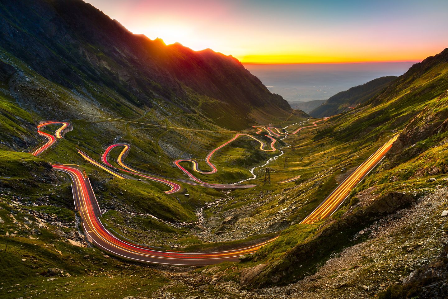 Traffic trails on Transfagarasan pass at sunset. Crossing Carpathian mountains in Romania, Transfagarasan is one of the most spectacular mountain roads in the world.