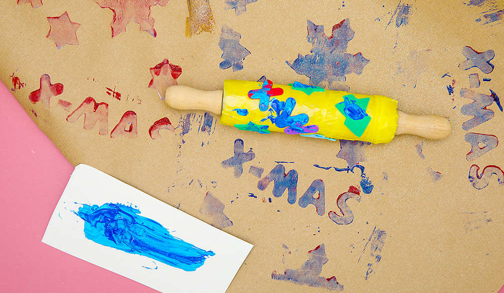 Nudelholz mit Moosgummi-Stickern auf Packpapier