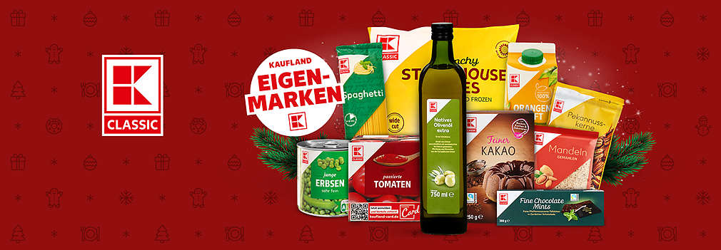 A festive display of K-Classic Ownbrand products, including olive oil, pasta, orange juice, and snacks, set against a red Christmas-themed background with holiday icons.