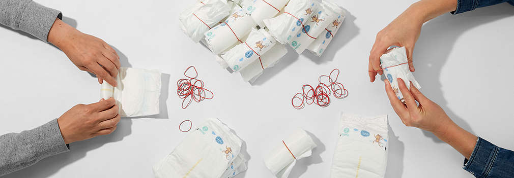 Many diapers are rolled up for the diaper cake