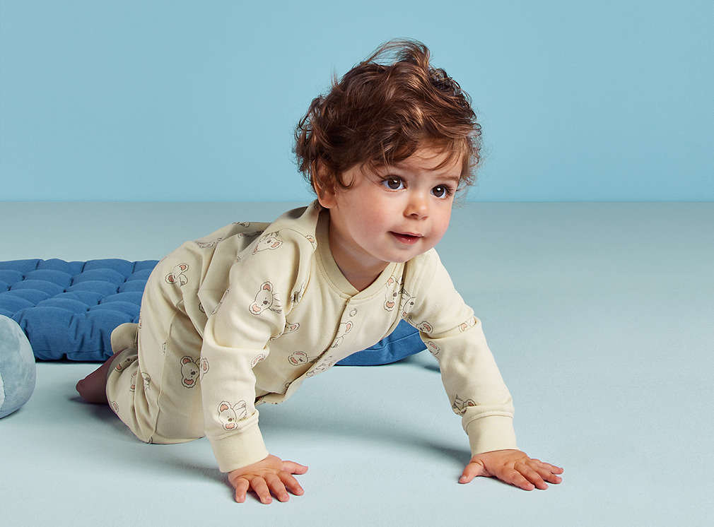 Baby crawling on the floor.