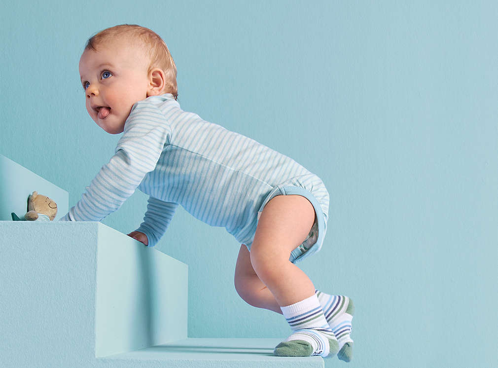 Toddler crawling up stairs.