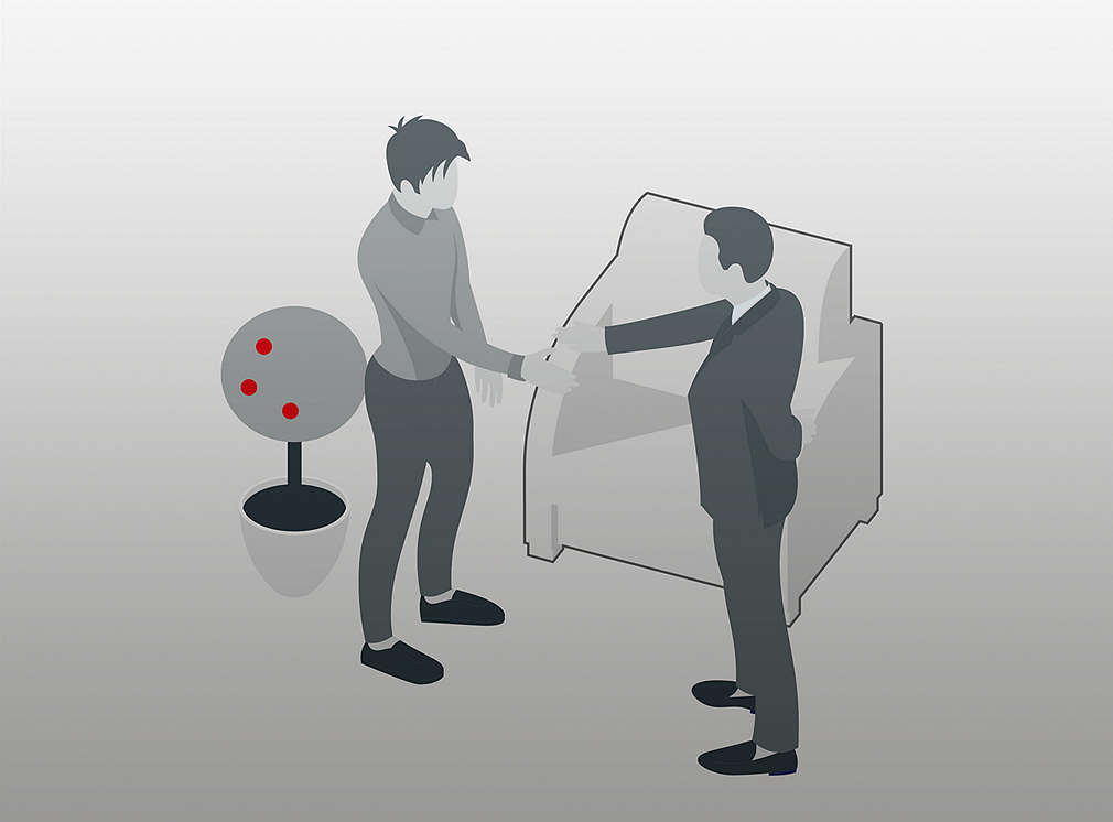 Two people in working atmosphere shaking hands