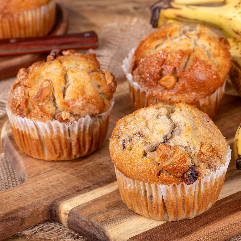Banana nut muffins and bananas on a wooden board