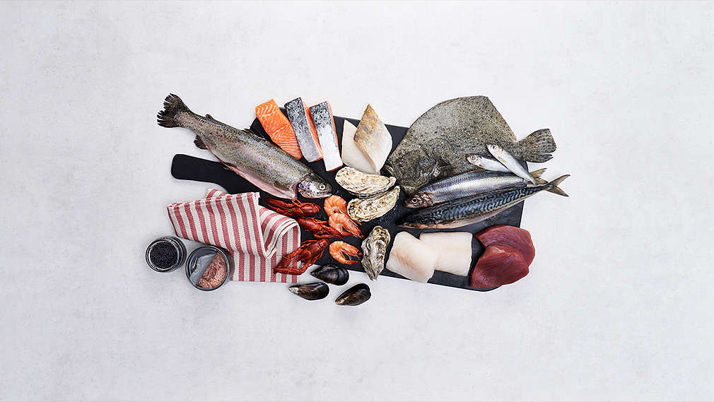 Various fish products on a wooden plate