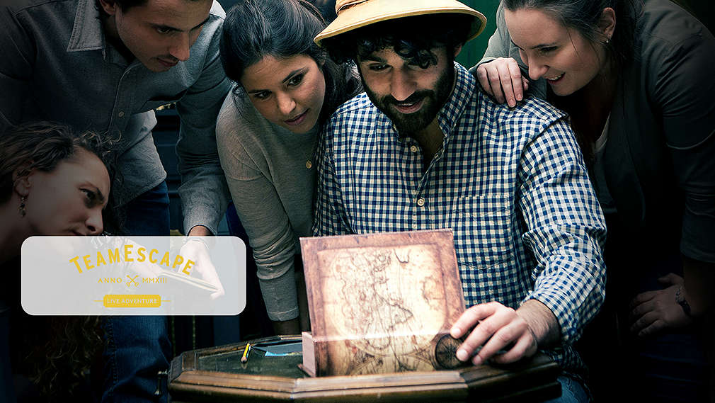 Abbildung: Mehrere Personen mit einem Rätsel; Logo: TeamEscape