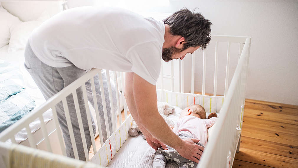 Vater am Babybett