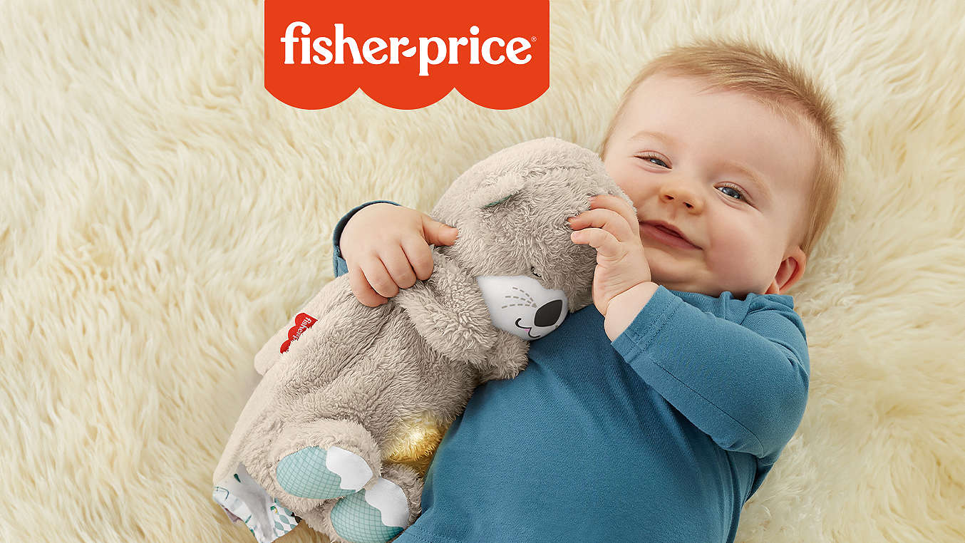 Logo: FISHER-PRICE; Abbildung: Baby mit FISHER-PRICE Schlummer-Spieluhr 