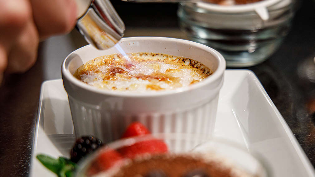 Ein Dessert wird in einer Schale karamellisiert